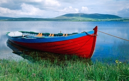scan photo red boat on blue lake